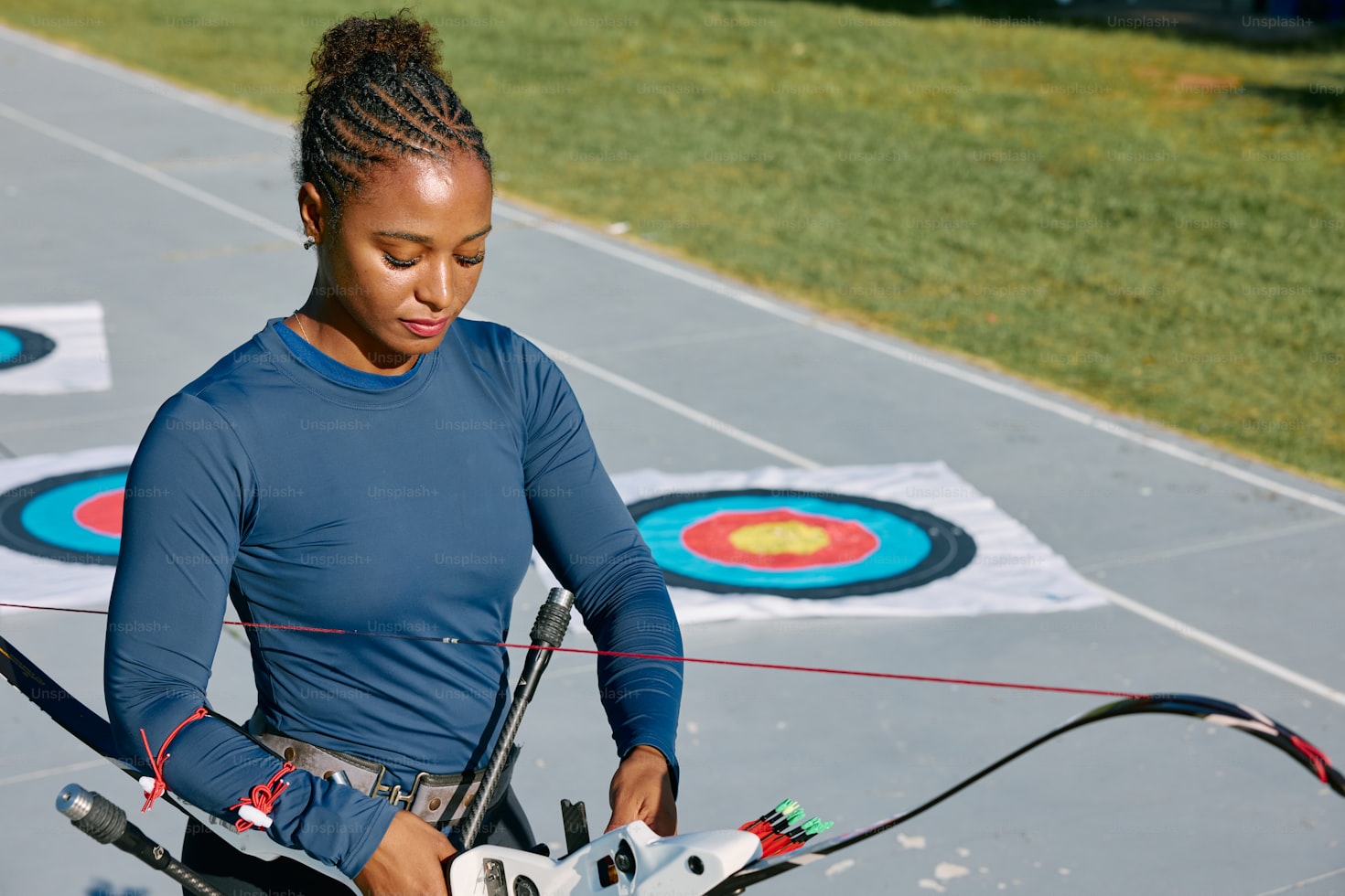 A person getting their bow ready for archery training