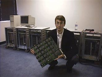 Photo of Paul Kocher holding a very large circuit board